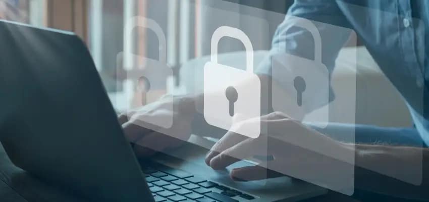 A laptop, presumably running security software, is displayed with a user's hands on the keyboard. Padlock icons are superimposed, likely indicating data protection.